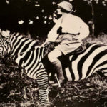 Osa rides a domesticated zebra at the base of Mount Kenya