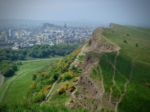 A view from Arthur's Seat of Holyrood Park trails and Old Town Edinburgh in the distance