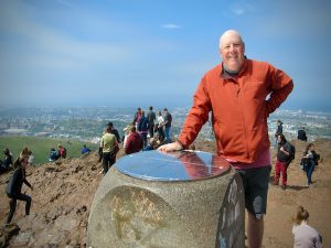 Standing at the not-too-difficult-to-climb summit of Arthur's Seat in Holyrood Park, Edinburgh