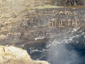 Tourists leave log messages beneath the falls
