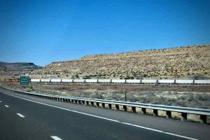 A fully-packed freight train runs alongside I-40 west of Albuquerque
