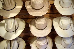 Cowboy hats line the walls at the Old Tucson gift shop