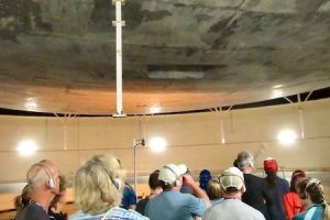 Tourists gaze up at the 16-ton metal plate, part of the lung that regulates air pressure inside Biosphere 2