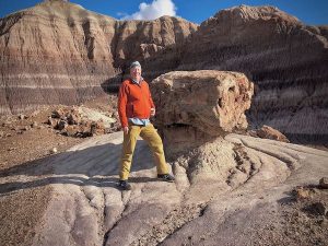 Steve stands by a massive remnant of an ancient tree at the Petrified Forest National Park, Arizona.